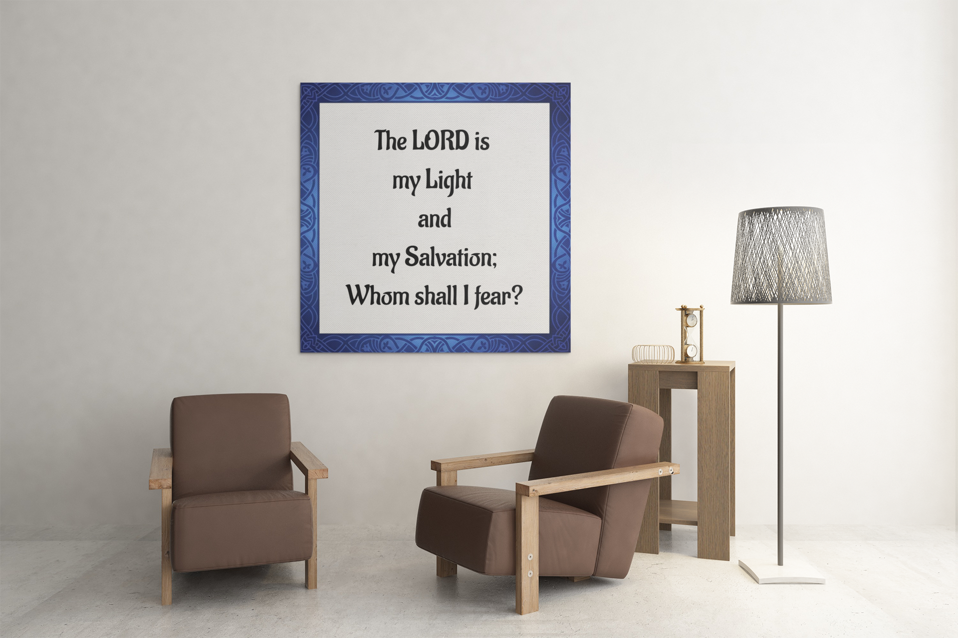 Two brown armchairs in a room with a framed  bible quote on the wall.